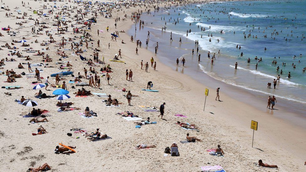People enjoy a beach in Sydney