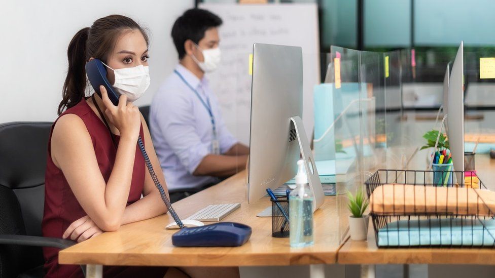 Generic image showing office workers wearing masks