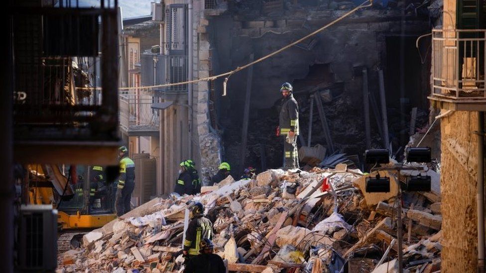Rescuers work at the site of a gas explosion that caused several houses to collapse in Ravanusa