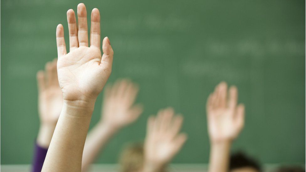 hands up in a classroom