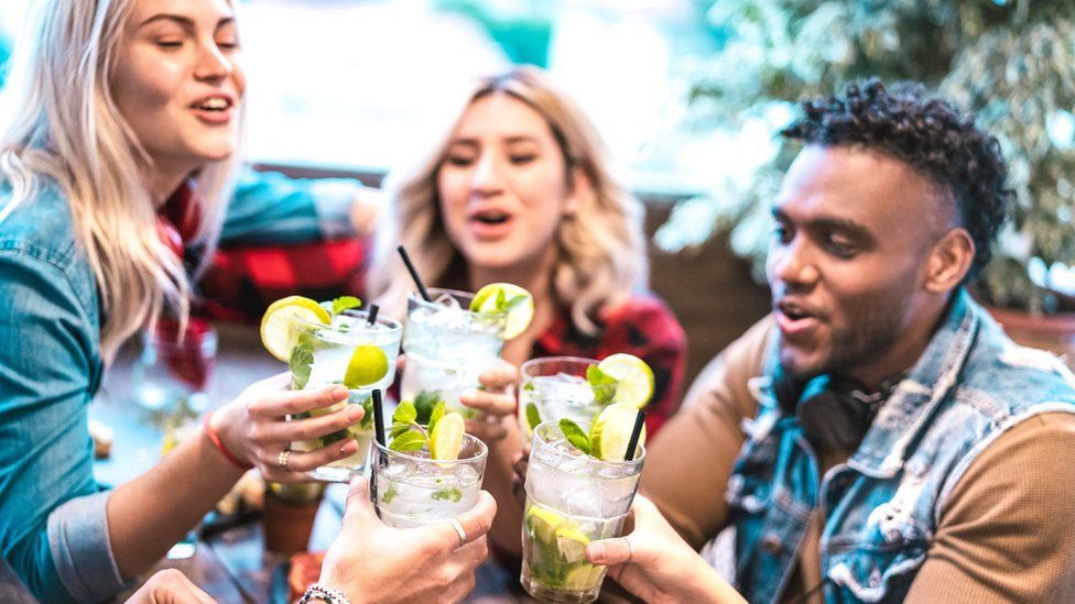 Young people drinking cocktails