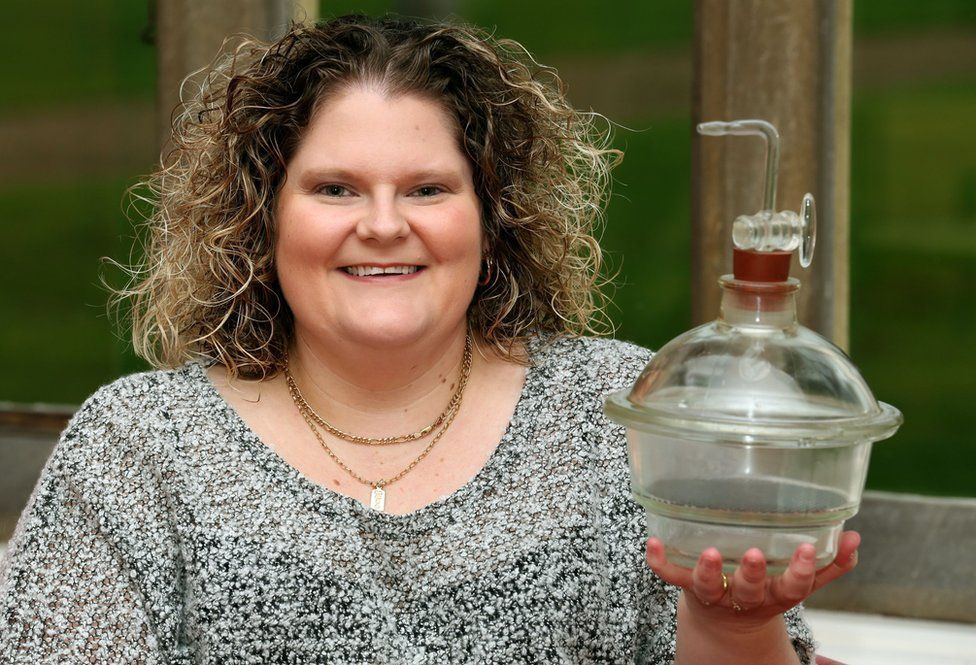 Louise Brown, the world's first test tube baby, holds the incubator jar in which her embryo was incubated