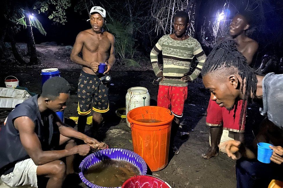 Men standing around at night