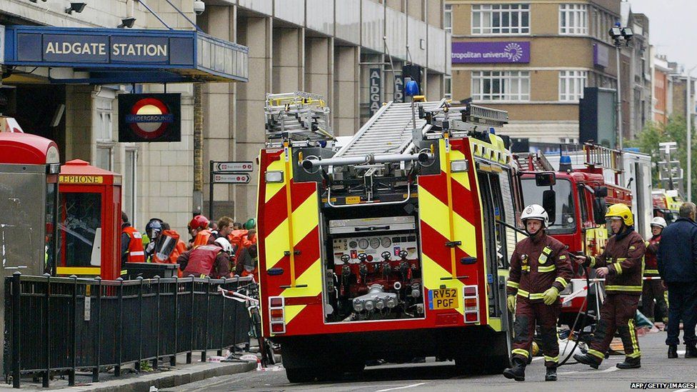 Police and fire personnel work outside London's Aldgate Station after an explosion occurred on the Circle line 07 July, 2005.