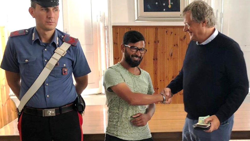 A police handout shows a 23-year-old man from Bangladesh being thanked after returning a wallet containing €2,000 in cash