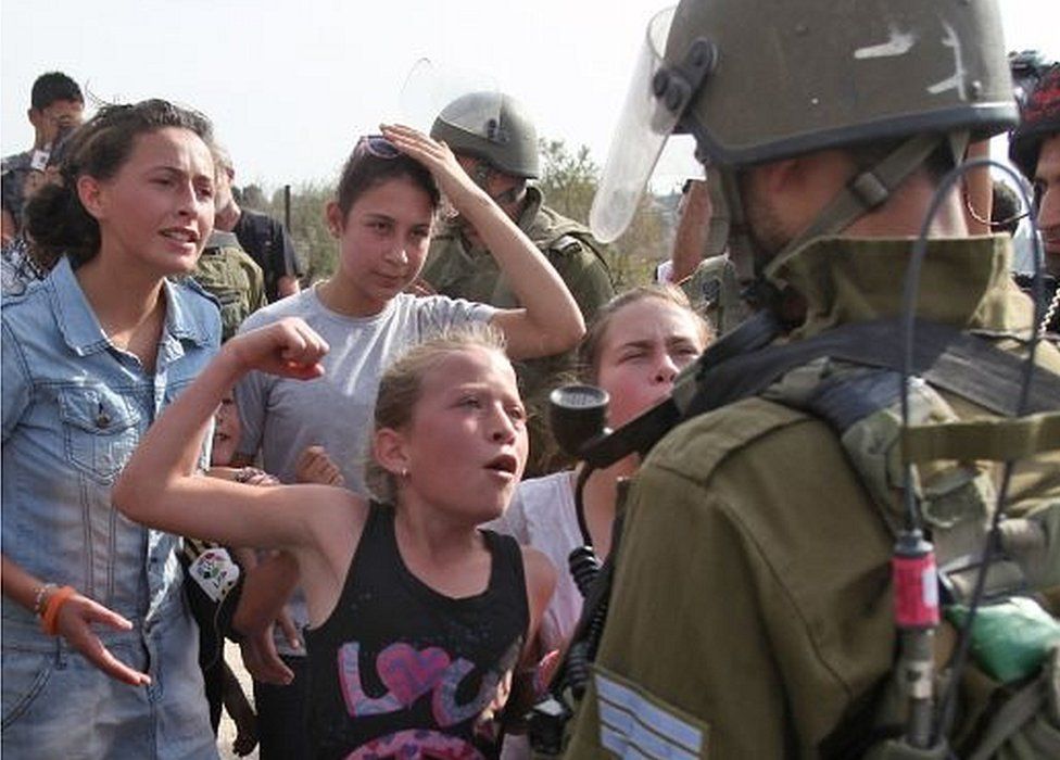 Ahed Tamimi gesturing as if to punch an Israeli soldier (02/11/12)