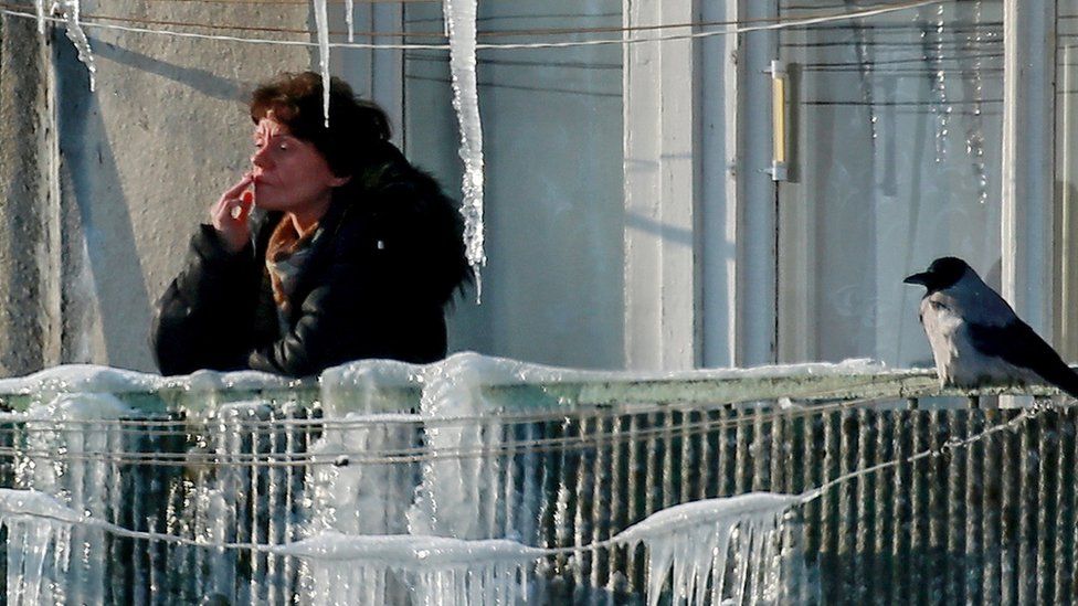 File pic of Russian woman smoking in the winter