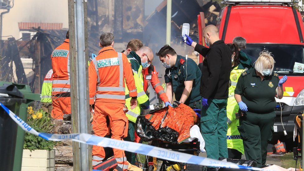 Paramedics attend to an injured person at the scene