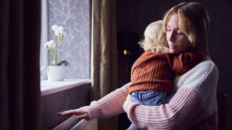 A woman holding a baby