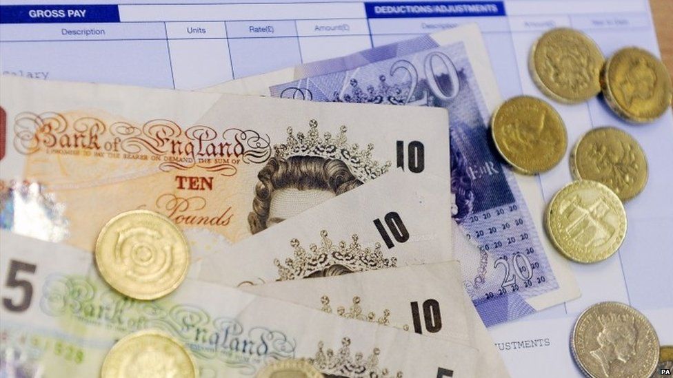 Pound notes, coins and pay slip
