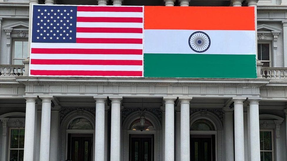 Flags of India and US adorn the Eisenhower Executive Office Building of the White House in Washington