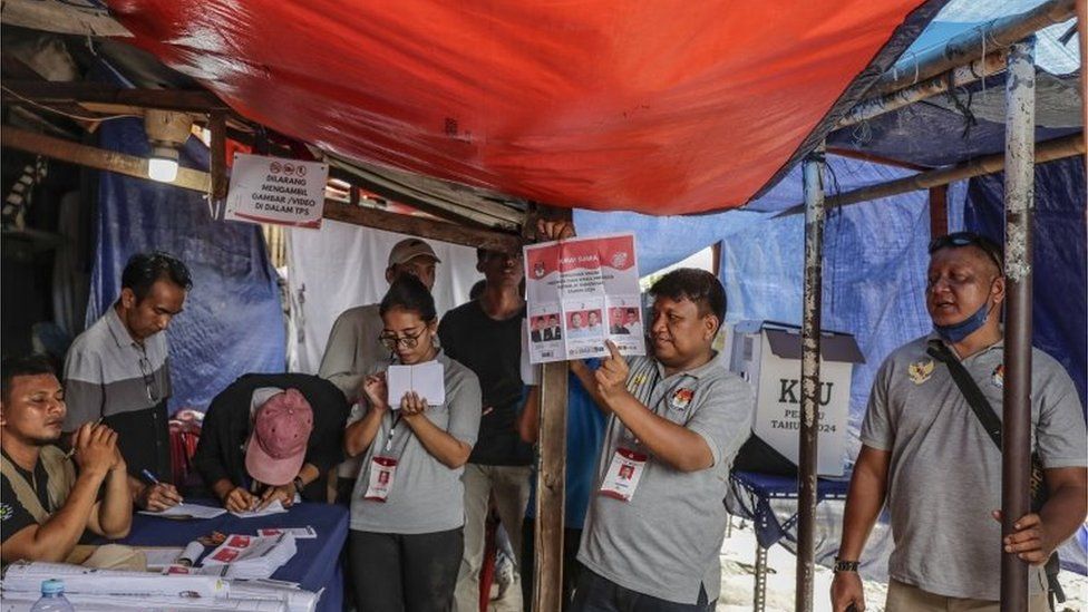 An election official holds a ballot during vote counting at a slum area in Jakarta, Indonesia, 14 February 2024.