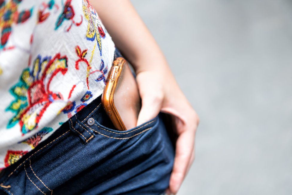 phone in woman's pocket
