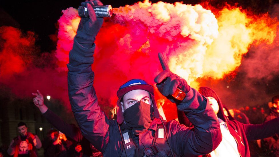 A protester holding a flare