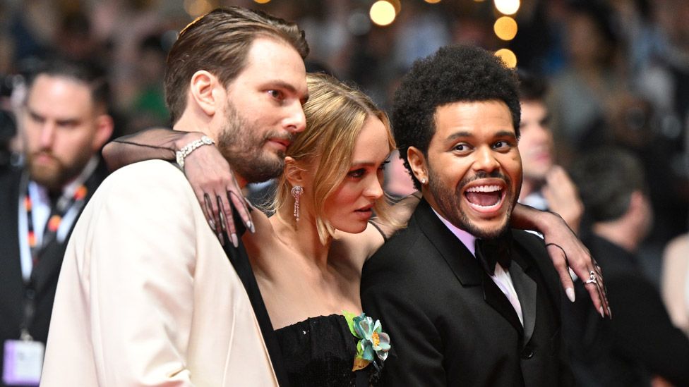 Sam Levinson, Lily-Rose Depp and Abel Tesfaye posing on the red carpet at The Idol premiere at the Cannes film festival