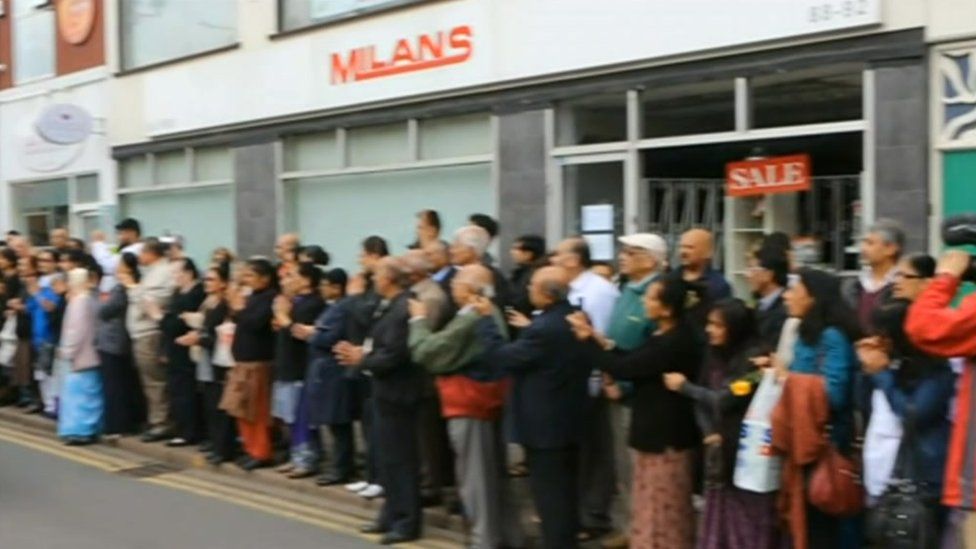 People paying their respects to Rakesh Chauhan outside Milans shop