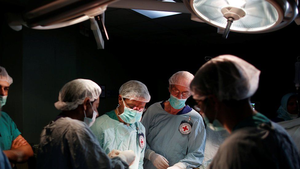 British vascular surgeon John Wolfe, who was invited to Gaza by the International Committee of the Red Cross (ICRC), performs a surgery for a wounded Palestinian in the operating room in a hospital in Gaza City April 25, 2018