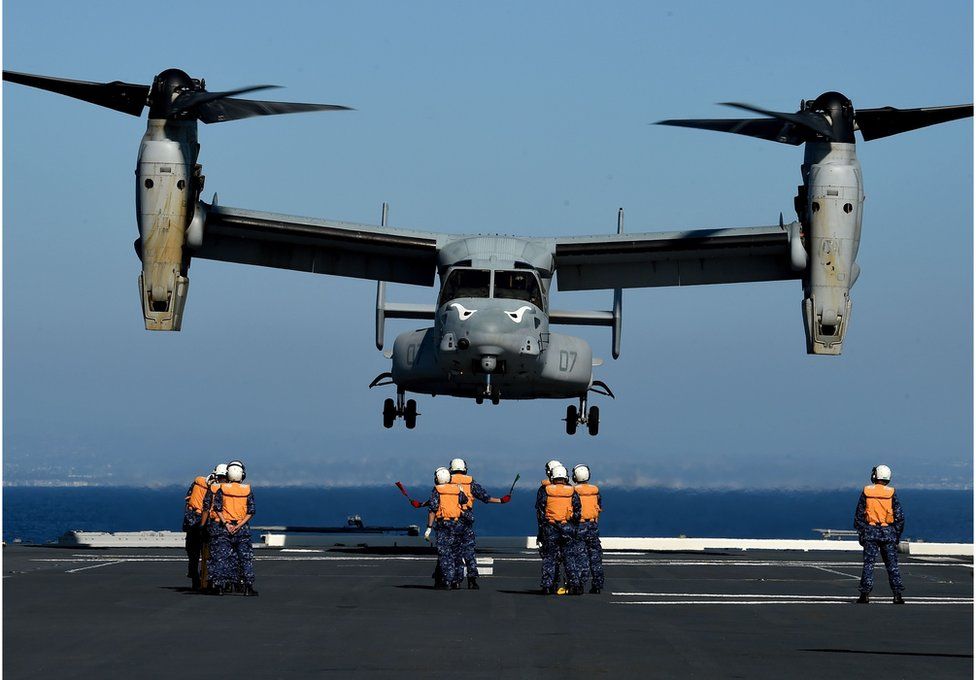 This file photo taken on 3 September 2015 shows Japanese Sailors on board the Japan Maritime Self-Defense Force (JMSDF) ship JS Hyuga directing a US Marines MV-22 Osprey to land during the Dawn Blitz 2015 exercise off the coast of Southern California.