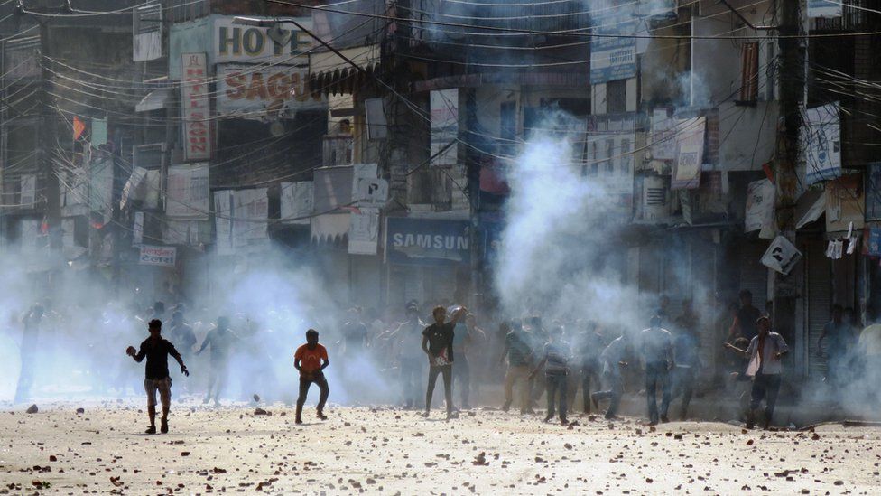 Nepalese protesters throw rocks at police during clashes near the Nepal-India border at Birgunj, some 90 km south of Kathmandu, on November 2, 2015