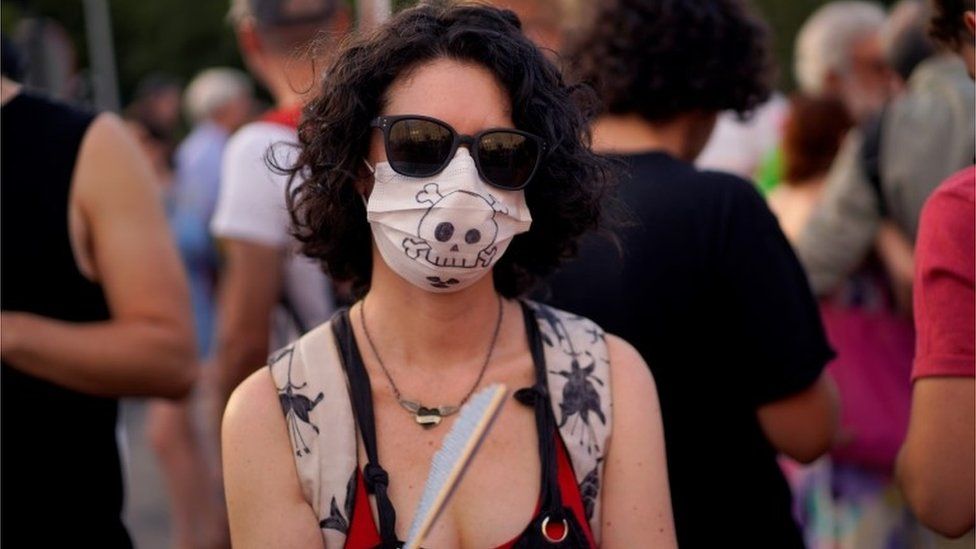 A woman in Madrid protests against the new mayor's decision to suspend a ban on polluting vehicles entering the city centre, 29 June 2019