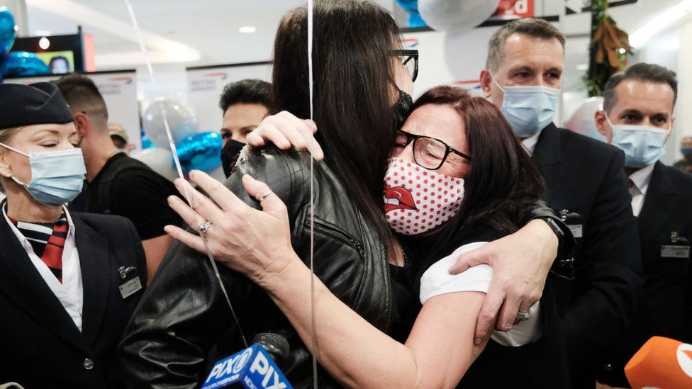 Jill Chambers (R) of Manchester, England is reunited with her sister Louise as passengers arrive from the first British Airways flight to arrive since the U.S. lifted pandemic travel restrictions on November 08, 2021 in New York City.