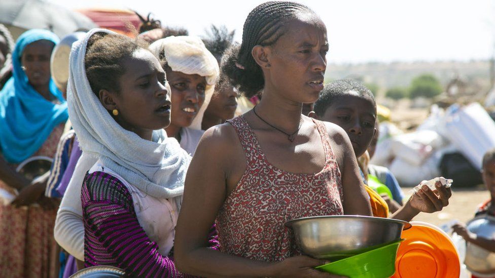 Ethiopians, who fled the conflict in the Tigray region in northern Ethiopia due to the clashes in the operation launched by the Federal Government Forces against the Tigray People's Liberation Front (TPLF), wait to reiceve food in Hamdayit camp after reaching Kassala State, Sudan on December 14, 2020