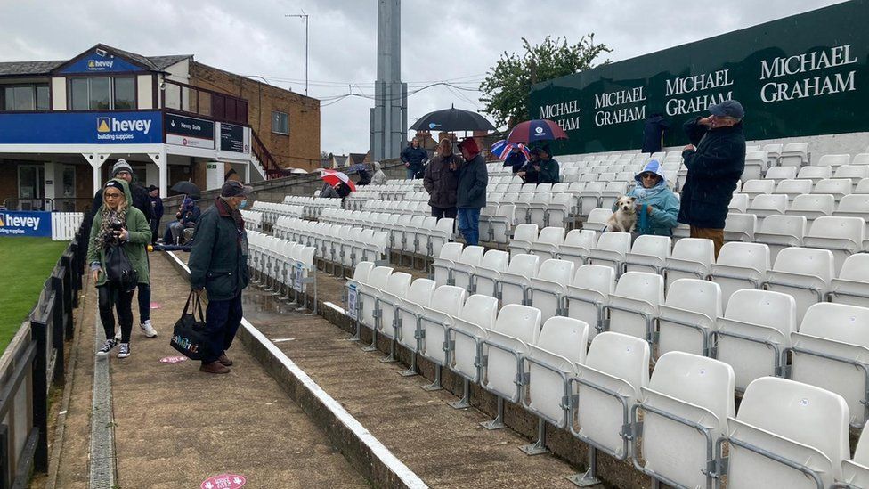 Spectators in stands at county cricket ground