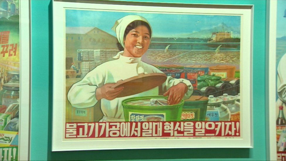 A printed poster saying ‘Let’s innovate the fish industry!’ Fishing is a dominant industry of the North Korean economy. (1981)