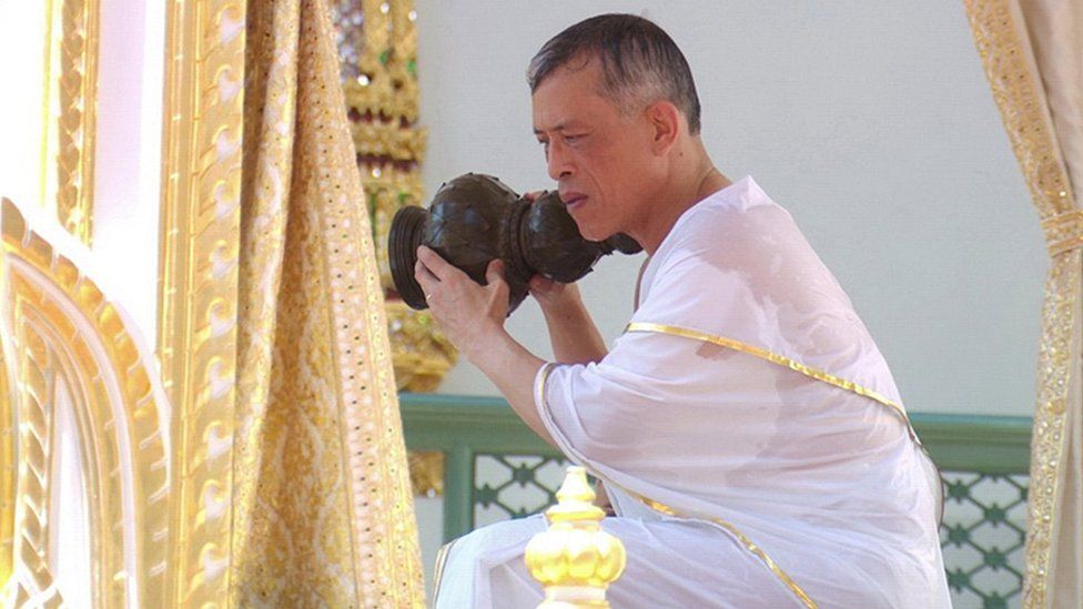 King Maha Vajiralongkorn, sat down, pouring holy water over his shoulders