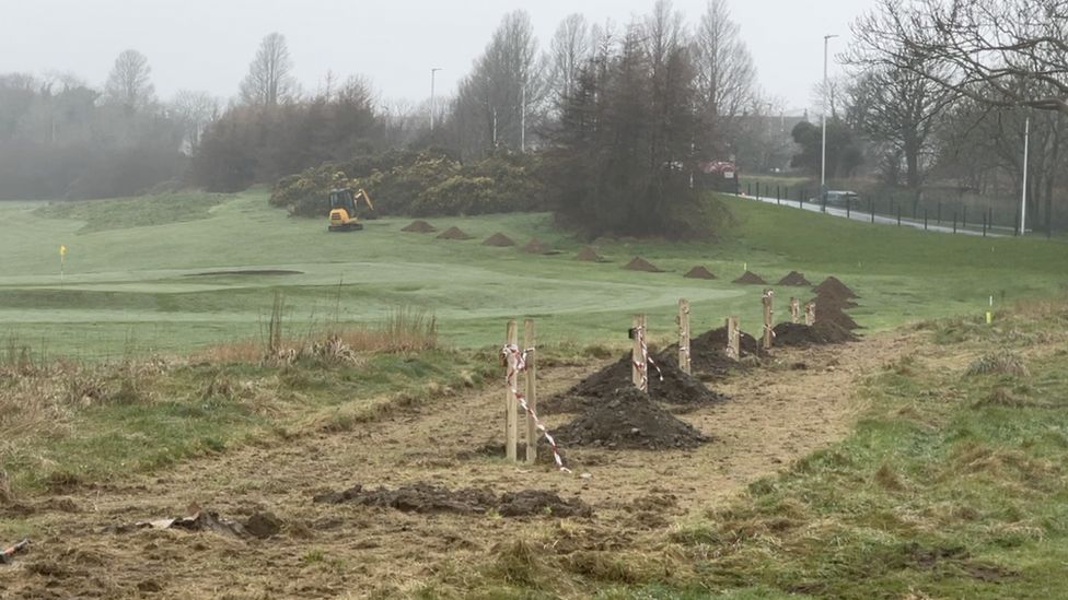 Holes dug along the outside of Douglas Golf Course for the trees to be planted