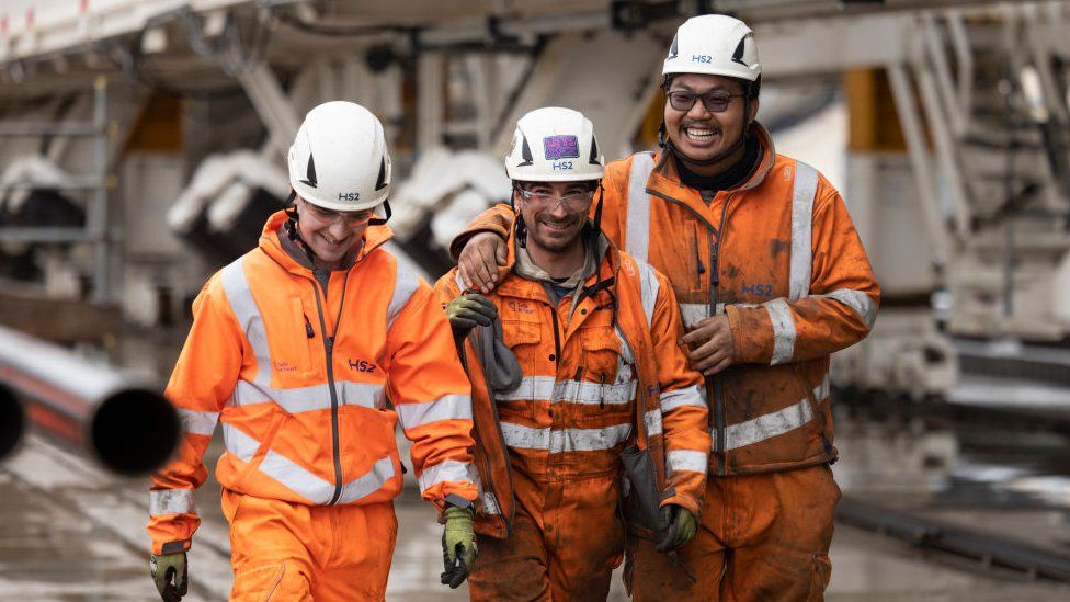Workmen walk from the tunnel as HS2 unveil their new tunnel boring machine