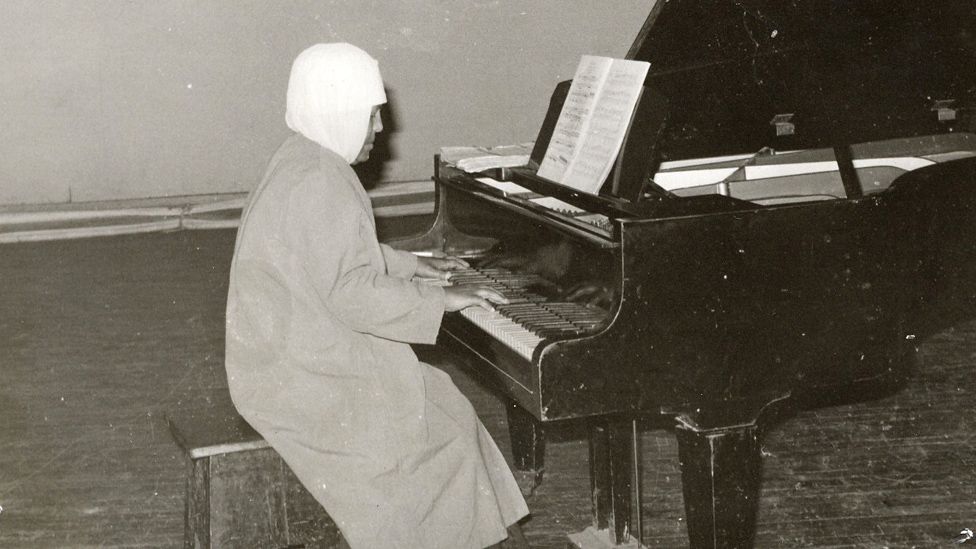 Emahoy playing the piano