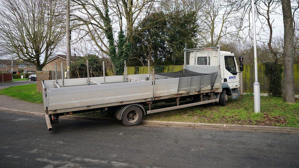 Flatbed lorry outside the gates in Marston Mortaine
