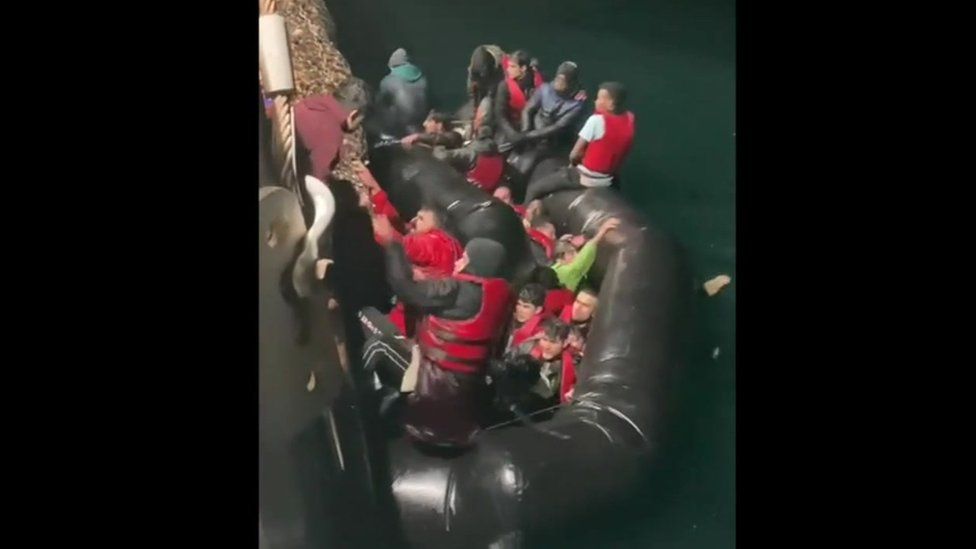 Footage from the rescue shows tens of people struggling to escape a deflating dinghy