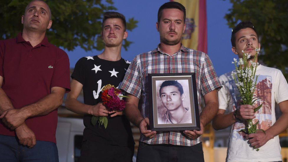 Kosovo Albanians hold portrait of Diamant Zabergja in Pristina city square to pay respect to the victims of shooting spree in Munich. 24 July 2016