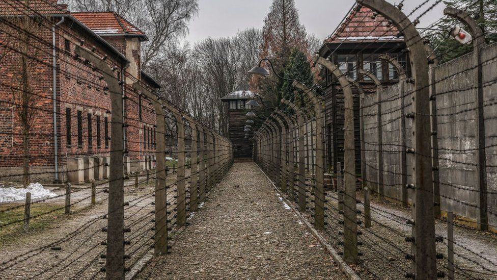 A photograph of barb wired fence in the former Nazi German Auschwitz camp