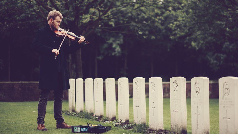 Sam Sweeney playing a violin at Ypres WWI cemetery