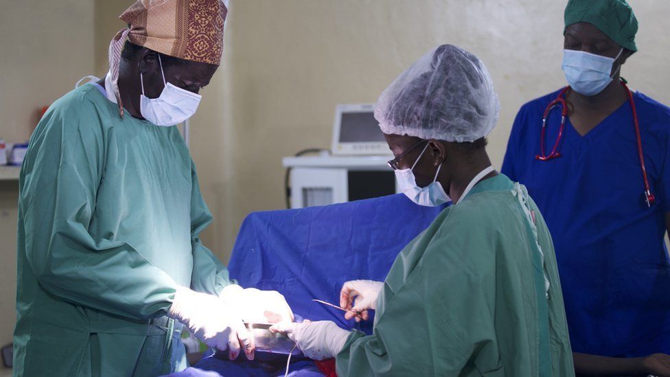 Dr Dut Pioth (to the left) performing a surgery