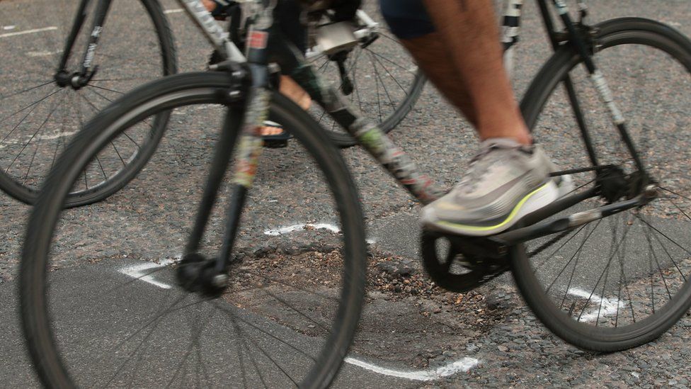 A bike going over a pothole