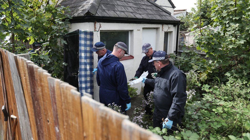 Officers were pictured searching the garden of the property on St Paul's Road