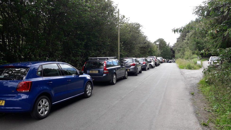 Cars parked at the side of the road near Moel Famau