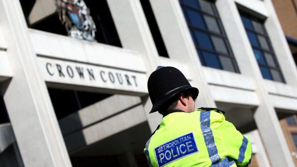 File photo of a Met police officer stood outside the entrance to Kingston Crown Court