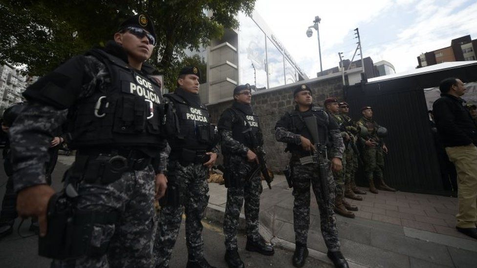 Security forces stand guard outside the National Electoral Council building in Quito on February 20, 2017, where supporters of Ecuadorean presidential candidate for the CREO party Guillermo Lasso, protest as they wait for the final results of Sunday"s presidential election.