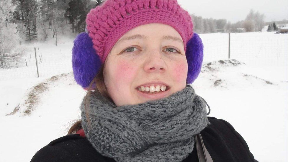 Sian Edwards, in snow with hat and ear muffs on