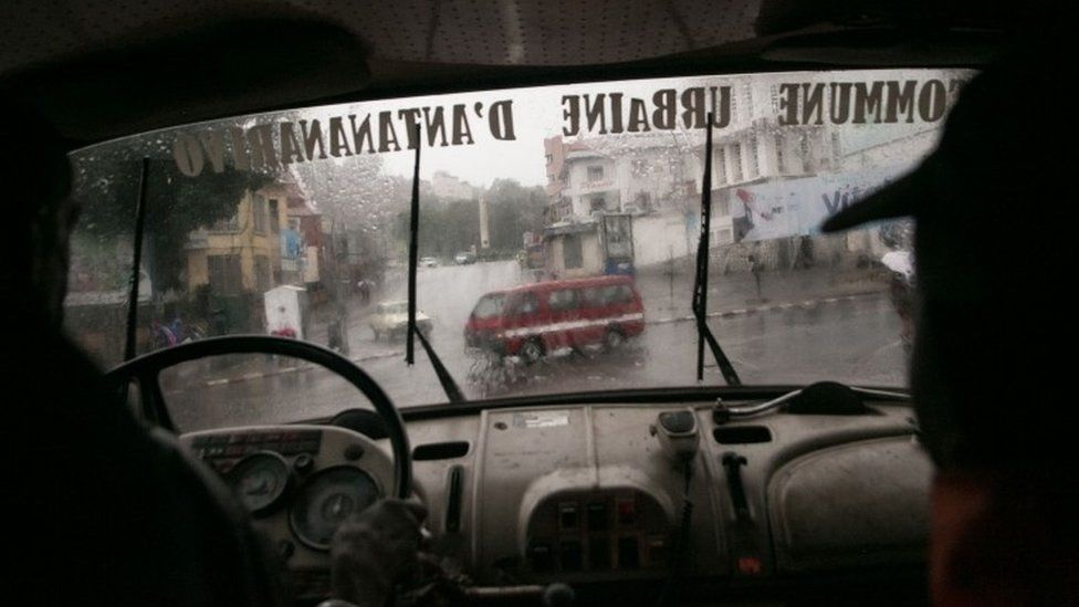 Malagasy firefighters drive around for emergency calls during tropical cyclone Enawo in Antananarivo, Madagascar, on March 8, 2017
