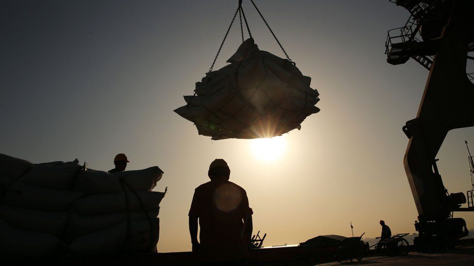 This file photo taken on April 9, 2018 shows workers transferring soybeans at a port in Nantong in China's eastern Jiangsu province.