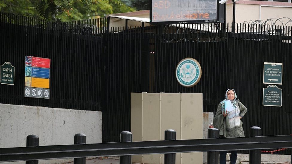 A woman waits at the US embassy in Ankara in October