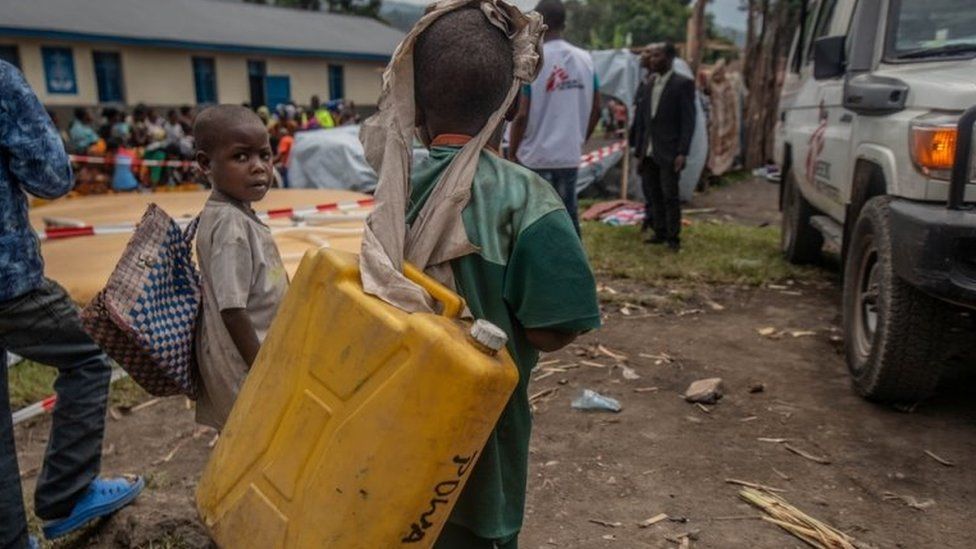 Displaced children wait to get drinking water at a distribution point near their temporary camp in Sake, eastern DR Congo. Photo: 28 May 2021