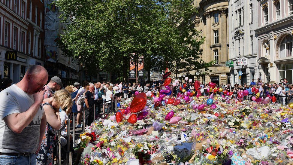 Flowers and tributes in St Ann's Square in Manchester