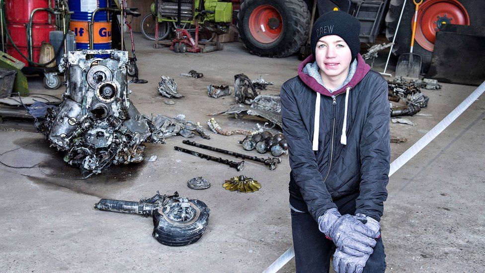 Daniel Kristensen poses with debris from the wreck of a World War II aircraft, which he and his father found yesterday near Birkelse by Aabybro in Northern Jutland